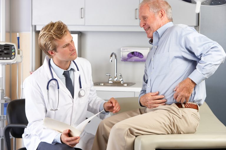 Doctor Examining Male Patient With Hip Pain Sleep Chillout